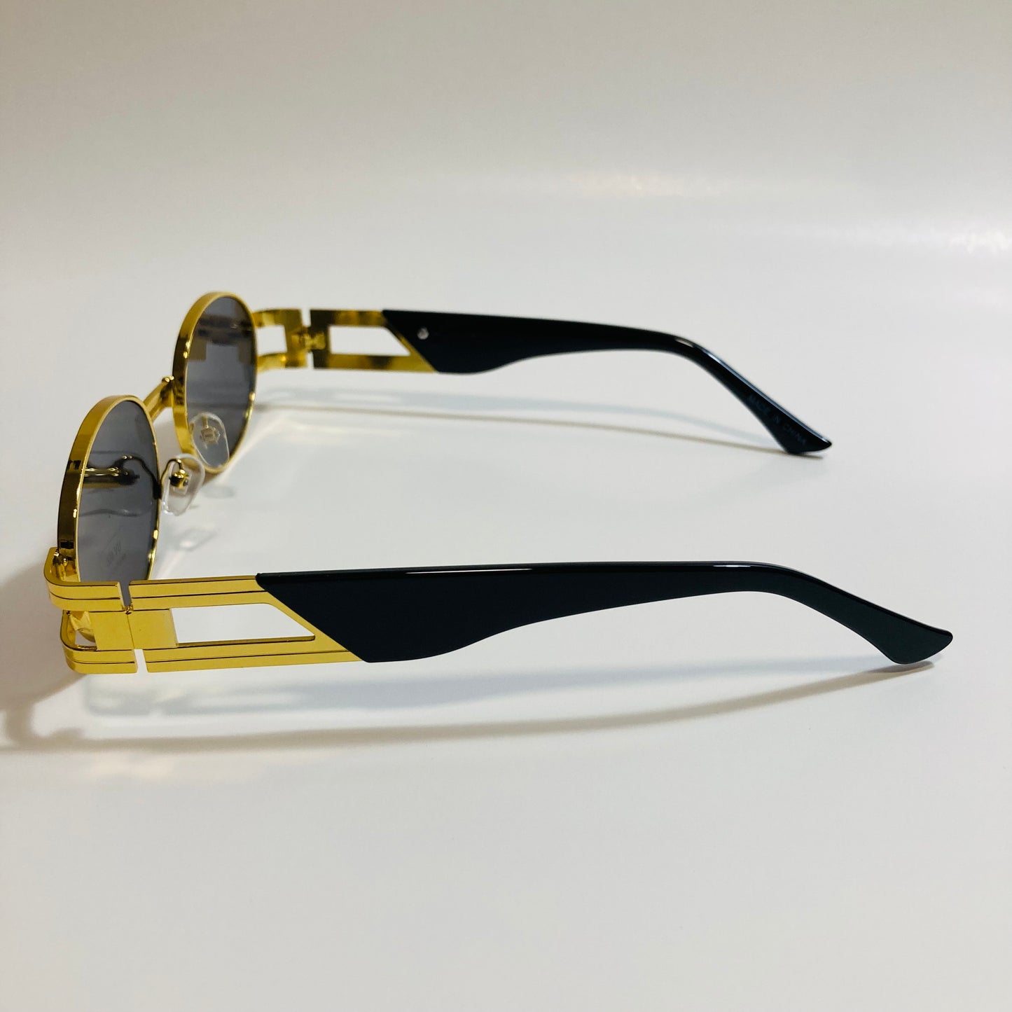 mens and womens gold and black round sunglasses
