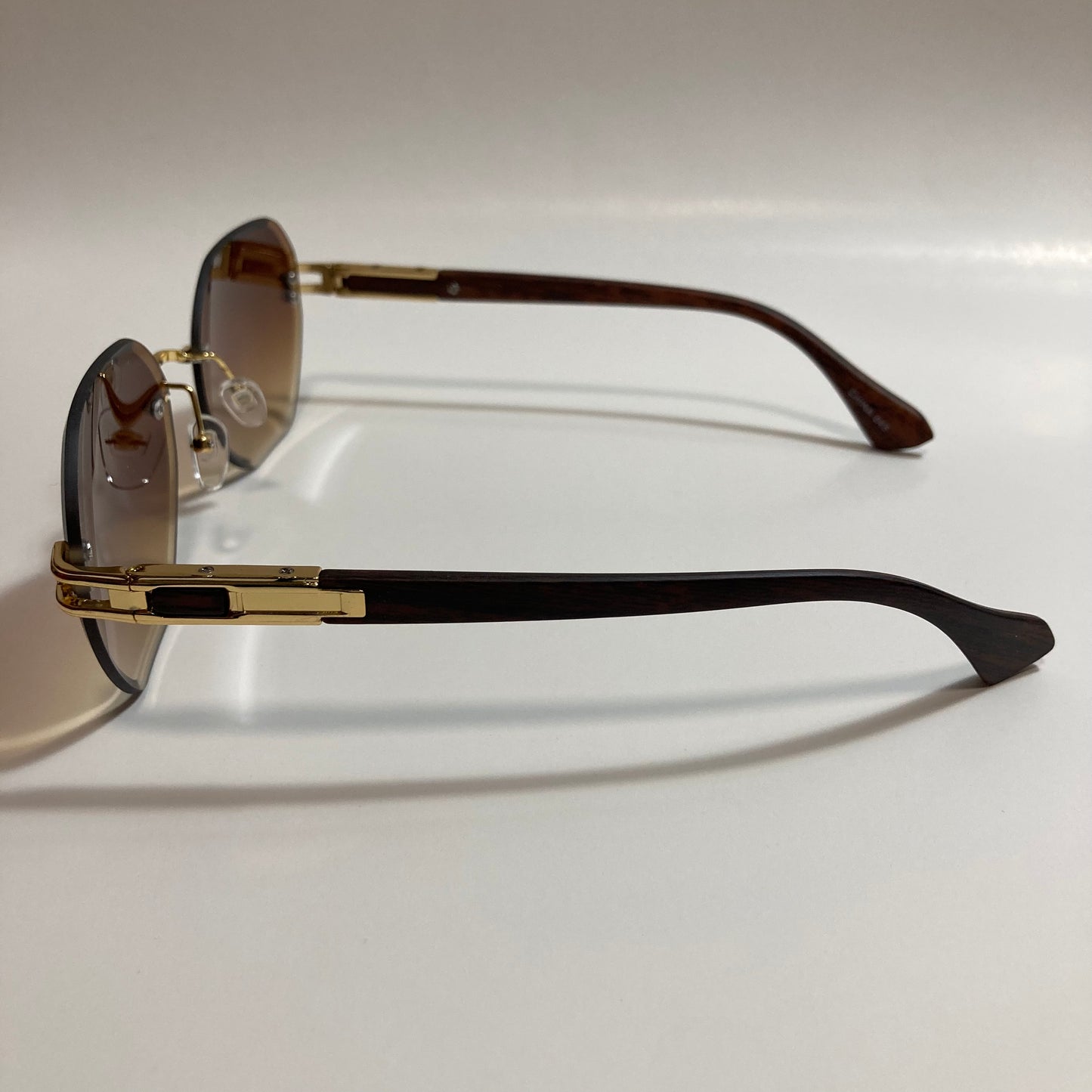 brown and gold rimless sunglasses