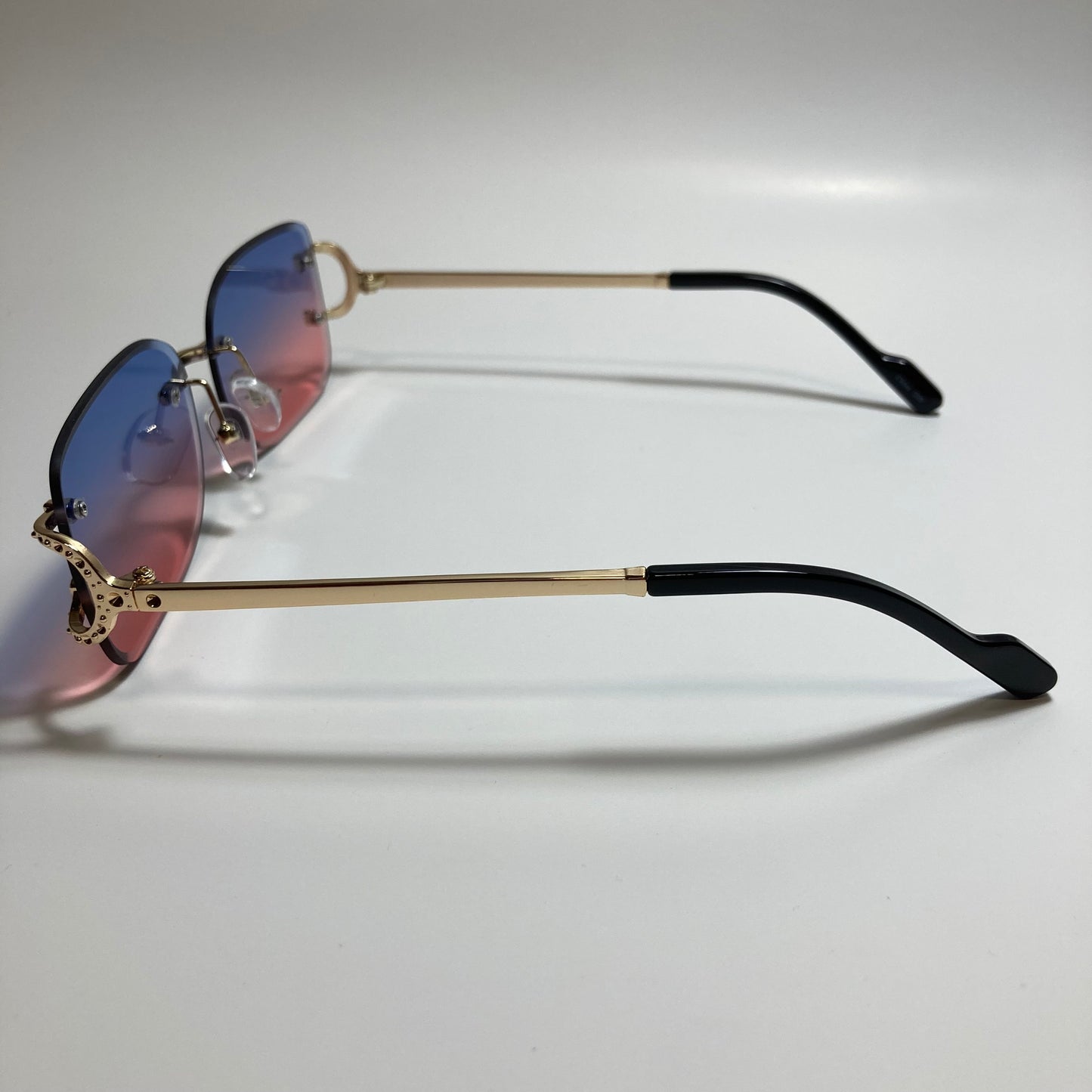 mens and womens pink blue and gold rimless square sunglasses