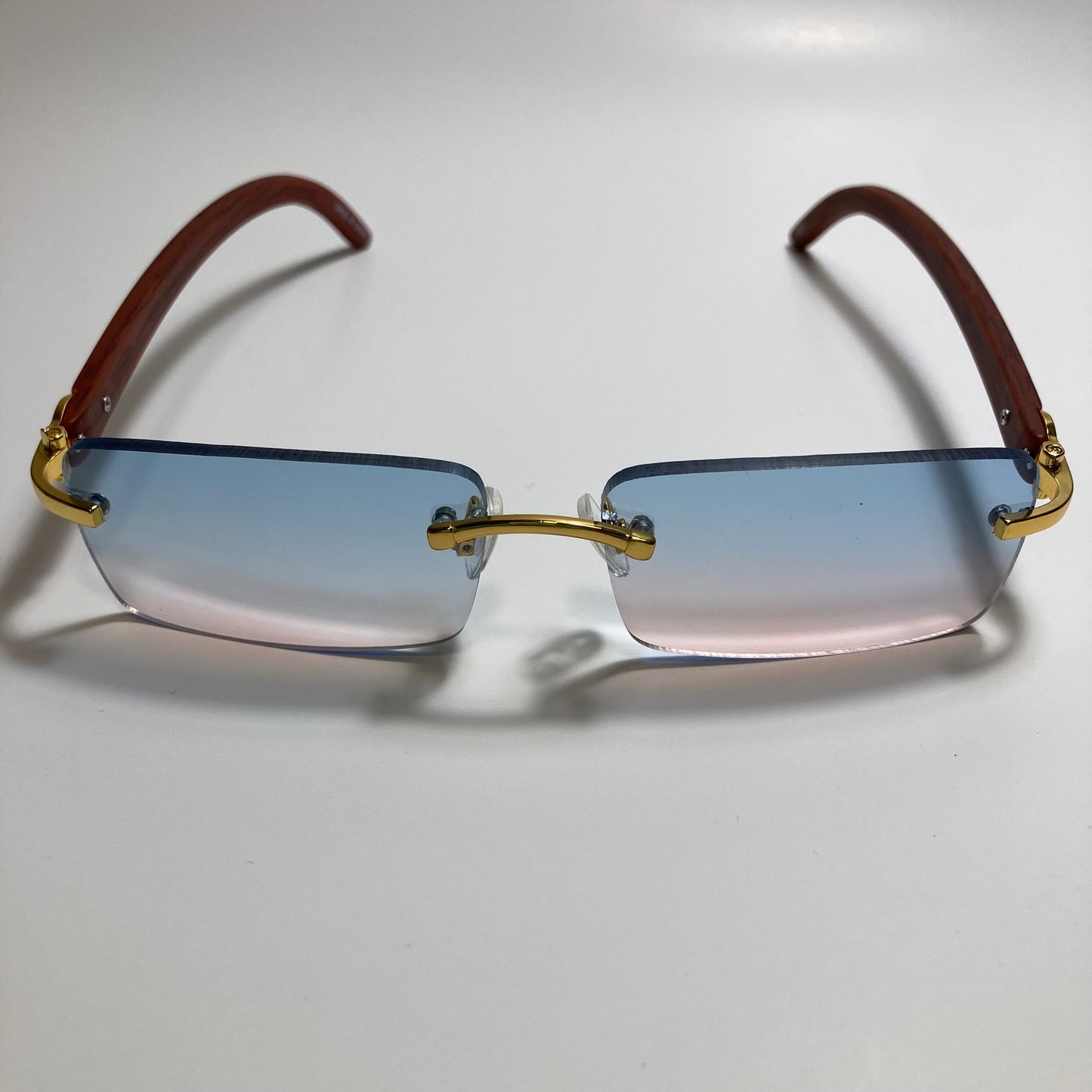 mens and womens pink and blue rimless square sunglasses