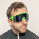 man wearing green and black wrap around sunglasses