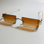 gold rimless womens sunglasses with brown lenses and flower accent
